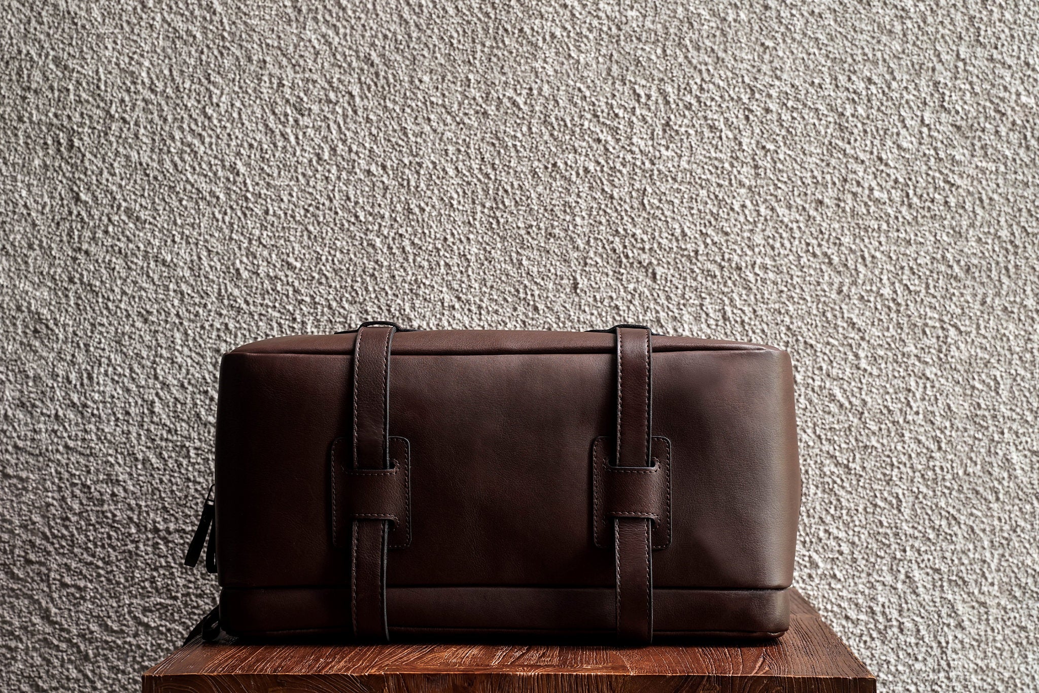 One of our signature design cues, the body straps go all around the bag, providing a load bearing structure for the bag. A big piece of leather on the bottom adds to the durability of the bag.